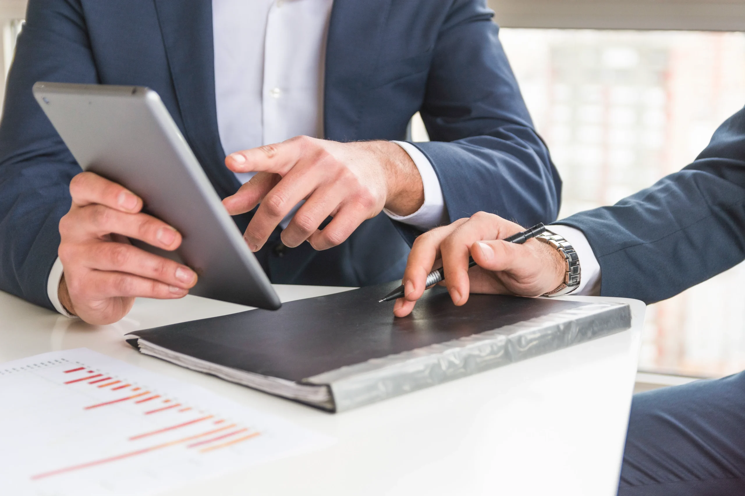 Businessman reviewing a licensing report on a tablet