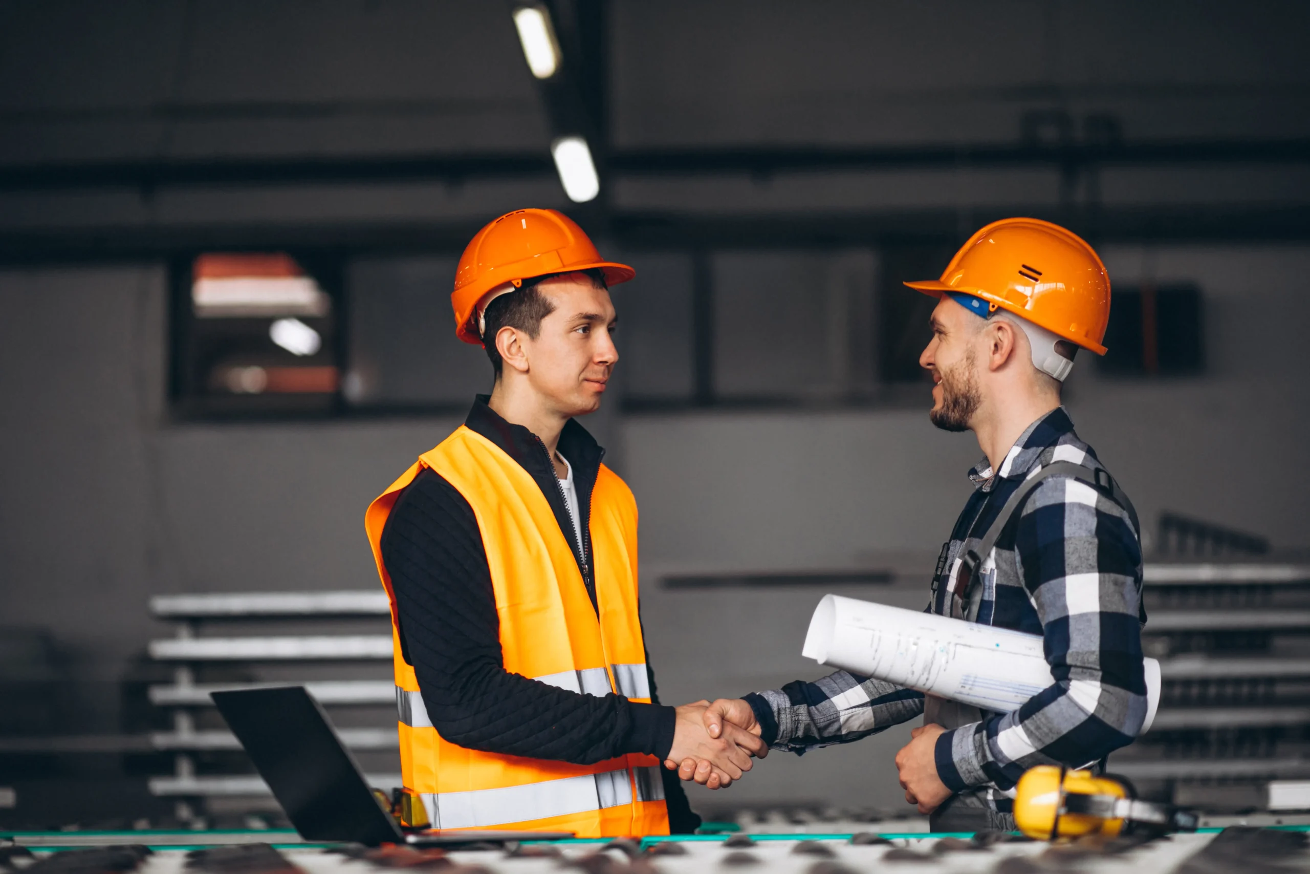 Two engineering colleagues reviewing work on a factory floor